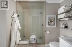 Glass-enclosed shower with subway tile surround and a chrome shower head - 