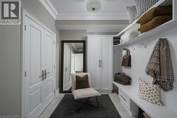 Entryway featuring double panel doors with brushed nickel hardware, built-in storage cabinetry, white shiplap wall paneling, and crown molding - 