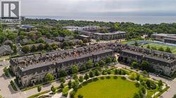 Aerial perspective of a multi-unit property with a stone façade and mansard roofs - 