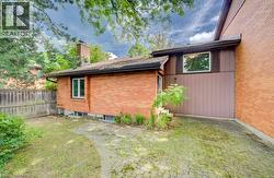 Exterior of a brick and vertical siding residence featuring a paved patio area - 