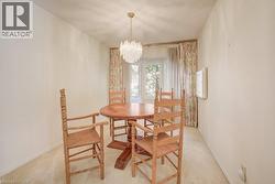 Bay window with ample natural light, accompanied by a decorative chandelier light fixture - 