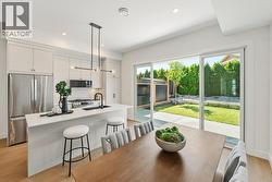 Kitchen & dining area, double sliding doors to back patio/yard - 