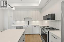 Kitchen with island, quartz counters, gas range - 