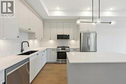 Kitchen with island, quartz counters, gas range - 