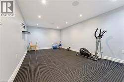 Spacious room featuring modular rubber flooring, recessed lighting, and integrated ceiling speakers - 