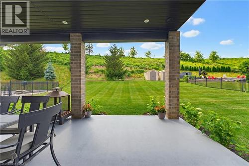 Covered patio with brick columns and recessed lighting - 38 River Valley Drive, Kitchener, ON 