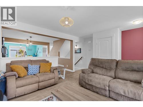 Stairs from the front entry/lobby in the background. Living room and kitchen area. - 128-1651 Lynrick Road, Kelowna, BC 