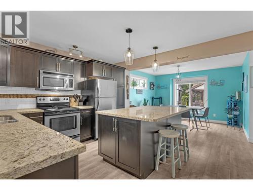 Kitchen with granite countertops and huge island. - 128-1651 Lynrick Road, Kelowna, BC 
