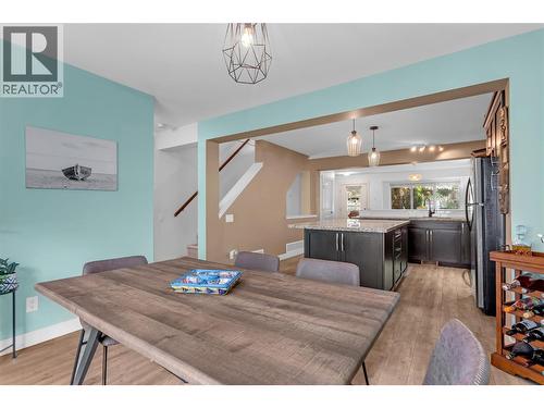 Dining area looking back into the kitchen with the living room in the background. - 128-1651 Lynrick Road, Kelowna, BC 