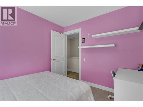 Third bedroom on the upper floor. Currently used as a gym Walk in closet in this room. - 128-1651 Lynrick Road, Kelowna, BC 