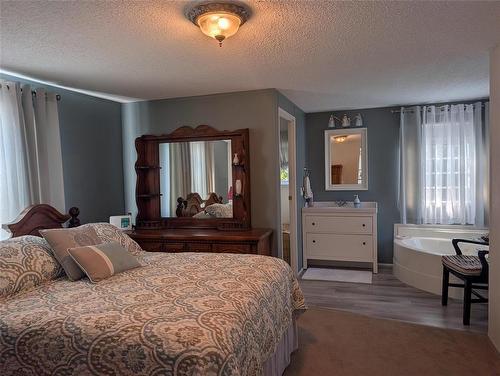 primary bedroom - 96 Shilo Road, Sprucewoods, MB - Indoor Photo Showing Bedroom