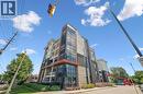 Modern multi-story building featuring expansive glazing, stone facade accents, and individual balconies with glass railings - 340 Plains Road E Unit# 507, Burlington, ON  - Outdoor With Facade 