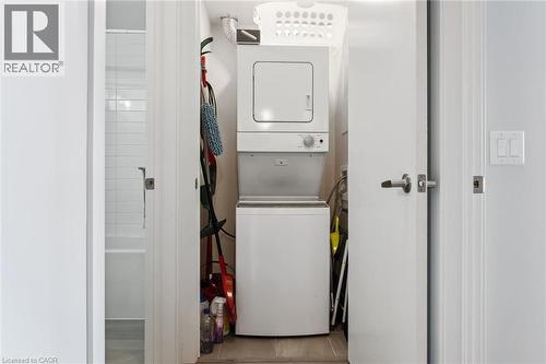 Dedicated laundry closet featuring a stacked washer and dryer unit - 340 Plains Road E Unit# 507, Burlington, ON - Indoor Photo Showing Laundry Room