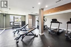 Dedicated fitness space featuring rubber flooring, recessed lighting, and a wood-finish ceiling accent - 