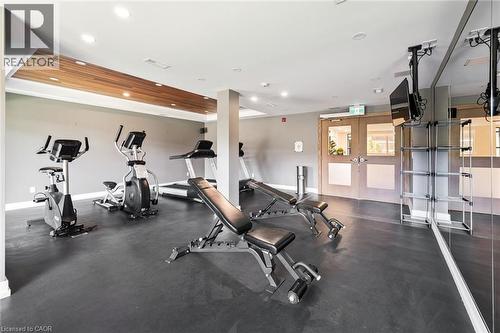 Indoor fitness area featuring dark gray flooring, a wood-finish ceiling accent, and recessed lighting - 340 Plains Road E Unit# 507, Burlington, ON - Indoor Photo Showing Gym Room
