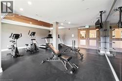 Indoor fitness area featuring dark gray flooring, a wood-finish ceiling accent, and recessed lighting - 
