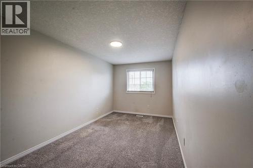 Interior room featuring grey textured carpet and neutral-toned walls - 208 Featherstone Crescent, Kitchener, ON - Indoor Photo Showing Other Room