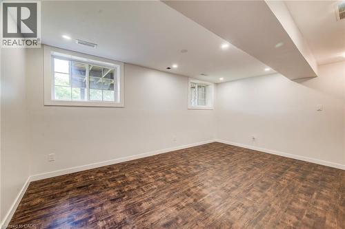 Spacious room featuring wood-finish flooring, recessed lighting, and white trim throughout - 208 Featherstone Crescent, Kitchener, ON - Indoor Photo Showing Other Room