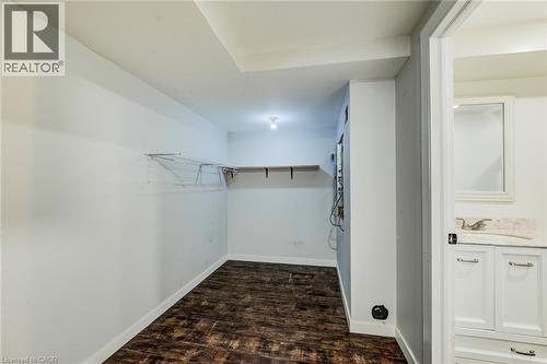 Versatile interior space featuring wood-finish flooring, white walls, and a built-in shelf - 208 Featherstone Crescent, Kitchener, ON - Indoor Photo Showing Other Room
