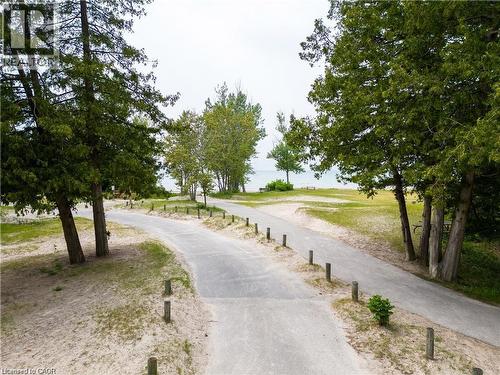 Paved pathways bordered by wooden posts and sand - 42 5Th Lane, Wasaga Beach, ON - Outdoor With View