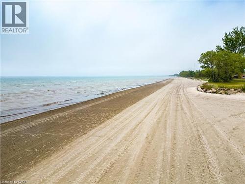 Expansive sandy beach frontage with water access, established trees, and natural shoreline - 42 5Th Lane, Wasaga Beach, ON - Outdoor With Body Of Water With View