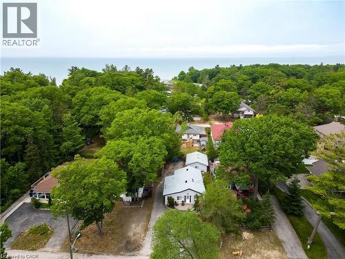 Aerial perspective showcasing a residential property nestled among mature trees - 42 5Th Lane, Wasaga Beach, ON - Outdoor With View