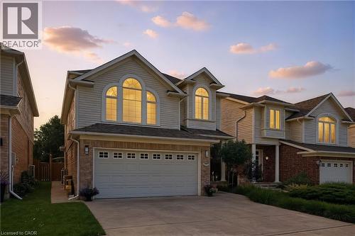 Two-story residence featuring light-colored siding and brick accents - 35 Dubrick Crescent, Kitchener, ON 