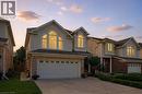 Two-story residence featuring light-colored siding and brick accents - 35 Dubrick Crescent, Kitchener, ON 