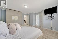 Light wood-finish flooring complements blue walls and white crown molding - 