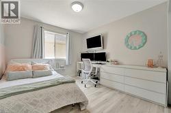 Light wood-finish flooring complements the neutral wall color - 