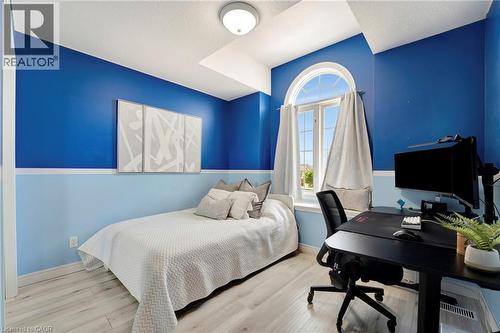 Bedroom featuring a vaulted ceiling, arched window, and light wood-finish flooring - 35 Dubrick Crescent, Kitchener, ON 