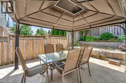 Patio area featuring a permanent gazebo structure with a fabric canopy - 