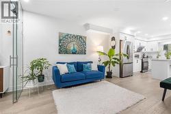 Living room with light wood finished floors and recessed lighting - 