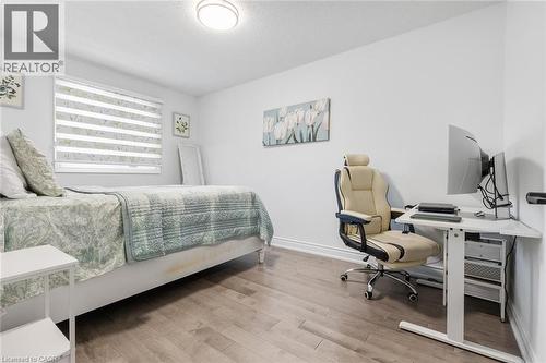 Bedroom with a desk, light wood-style flooring, and a textured ceiling - 1118 Avondale Drive, Oakville, ON 