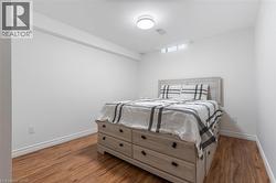 Bedroom with light wood-style floors and baseboards - 