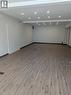 Spacious interior room featuring wood-finish flooring, recessed lighting, and light-toned wall paint - 499 Main Street E, Hamilton, ON 