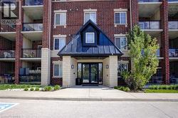Brick exterior featuring a prominent gabled entrance with black metal roofing - 