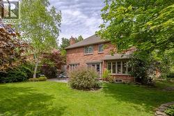 Red brick exterior featuring multiple windows and a gabled roof - 