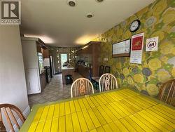 Dining area featuring patterned wallpaper and recessed lighting - 