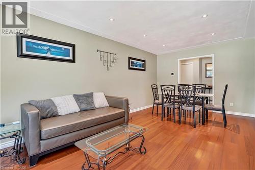 Open-concept living and dining area featuring rich wood-finish flooring - 234 Thunderbird Drive, Cambridge, ON - Indoor