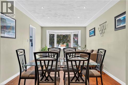 Dining area featuring warm wood-finish flooring, recessed lighting, and a bay window - 234 Thunderbird Drive, Cambridge, ON - Indoor Photo Showing Dining Room