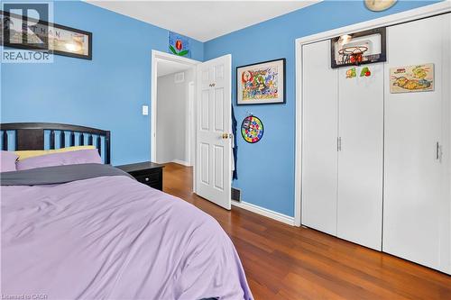 Bedroom with wood-finish flooring and a closet featuring bi-fold doors - 234 Thunderbird Drive, Cambridge, ON - Indoor Photo Showing Bedroom