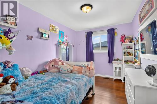 Interior room featuring wood-finish flooring, a white trim window, and overhead lighting - 234 Thunderbird Drive, Cambridge, ON - Indoor Photo Showing Bedroom