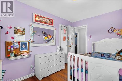 Bedroom featuring wood-finish flooring and a white paneled door - 234 Thunderbird Drive, Cambridge, ON - Indoor Photo Showing Bedroom