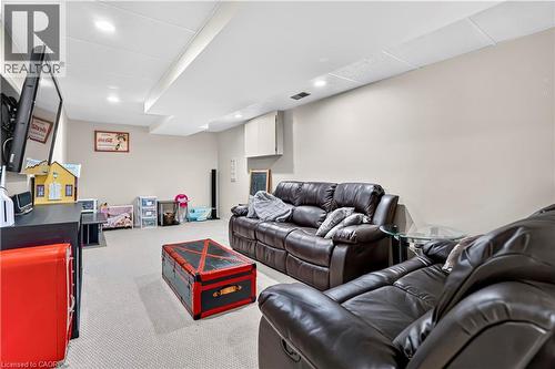 Finished lower level featuring recessed lighting, a drop ceiling, light neutral wall tones, and carpeting - 234 Thunderbird Drive, Cambridge, ON - Indoor Photo Showing Basement