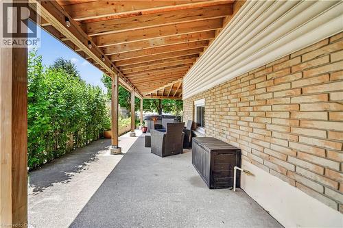 Expansive covered patio featuring a natural wood ceiling, exposed beams, and integrated lighting - 234 Thunderbird Drive, Cambridge, ON - Outdoor With Exterior