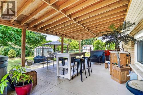 Expansive covered patio featuring a wood-finish ceiling, concrete flooring, and recessed lighting - 234 Thunderbird Drive, Cambridge, ON - Outdoor With Deck Patio Veranda