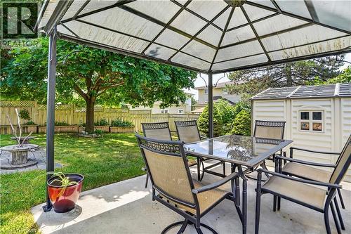 Concrete patio featuring a gazebo structure, a manicured lawn, and a storage shed - 234 Thunderbird Drive, Cambridge, ON - Outdoor With Deck Patio Veranda With Exterior