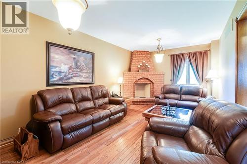 Family room with brick wood fireplace, hardwood flooring. - 2560 Rugby Road, Mississauga, ON 