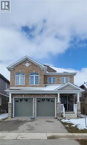 Two-story residence featuring a brick and stone facade, a covered front porch with pillars, and a double-door garage - 939 Hannah Avenue S, Listowel, ON 